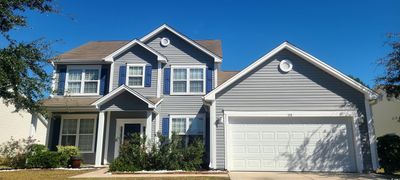 View of front facade featuring a garage | Image 1