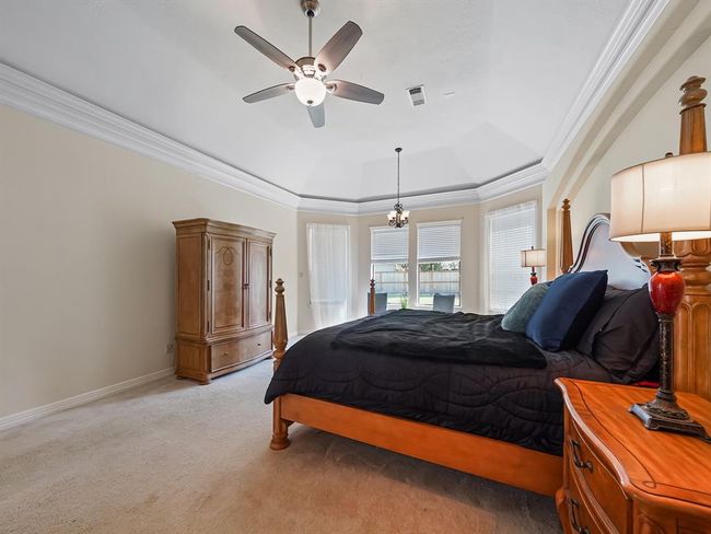 Spacious master bedroom featuring abundant natural light and soaring ceilings. | Image 24