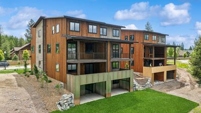 Back of units showcasing lower level deck and two patios | Image 3