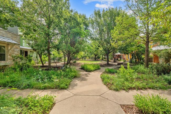 The sidewalks lined with trees create a picturesque stroll to and from the home, adding a touch of natural beauty and offering a peaceful, shaded path to enjoy year-round | Image 35