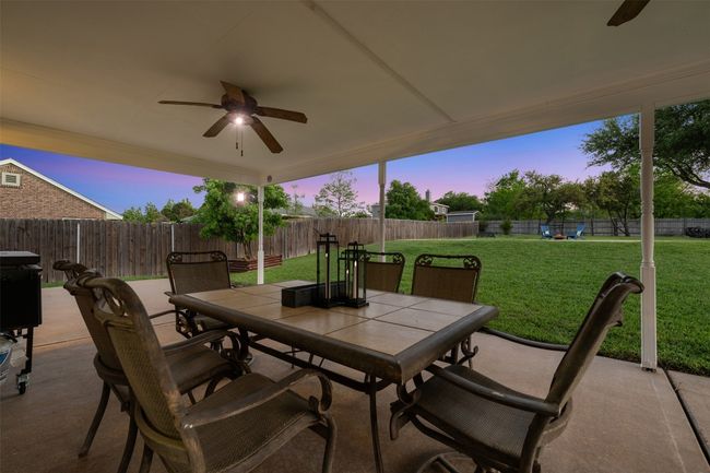 View of patio / terrace featuring outdoor dining space, ceiling fan, and a fenced backyard | Image 35