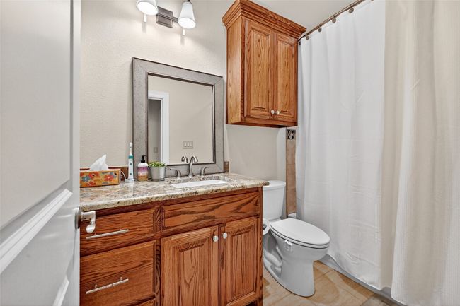 Full bath featuring vanity, tile patterned flooring, and a shower with shower curtain | Image 33