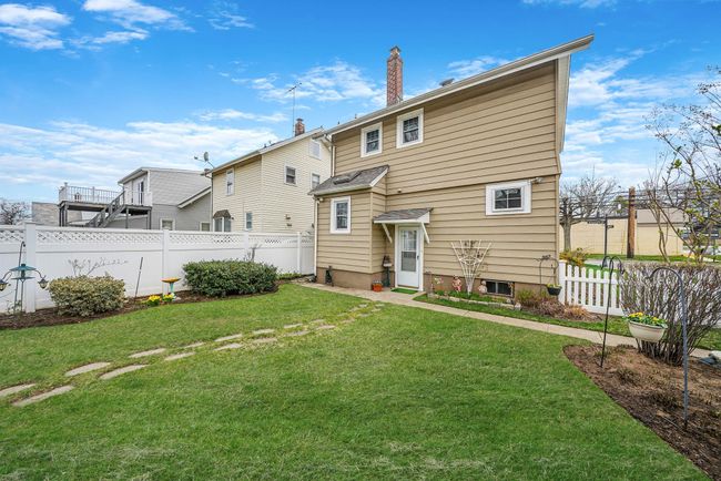 Back of property with fence, a yard, and a chimney | Image 27