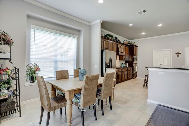 The area features a large window, neutral wall colors, and easy-to-maintain tile flooring. | Image 18
