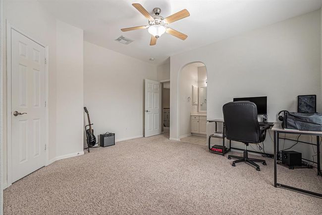 As we venture upstairs, we find 3 secondary bedrooms each with their own character and charm! A jack-n-jill bath just off this bedroom offers a private vanity too! | Image 25