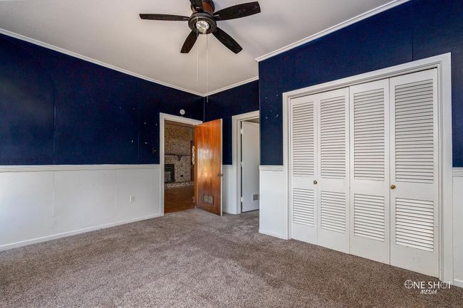 Unfurnished bedroom featuring ornamental molding, a closet, ceiling fan, and carpet flooring | Image 22
