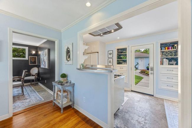 The kitchen has delightful built-ins and a unique mix of concrete, wood, and stainless steel. | Image 9