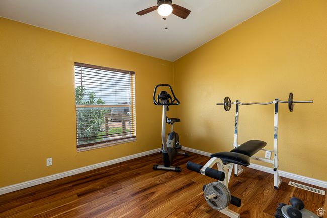 Workout room with hardwood / wood-style flooring, ceiling fan, and lofted ceiling | Image 21