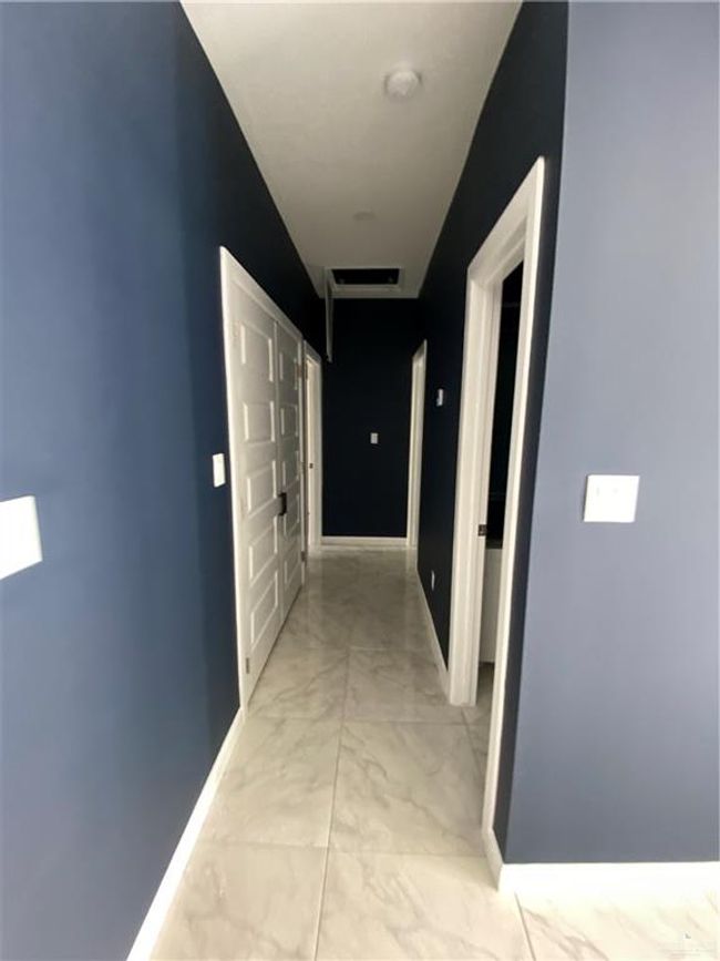 Hallway with light marble finish floors and baseboards | Image 9