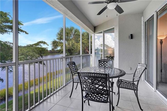 Balcony with a water view and ceiling fan | Image 7