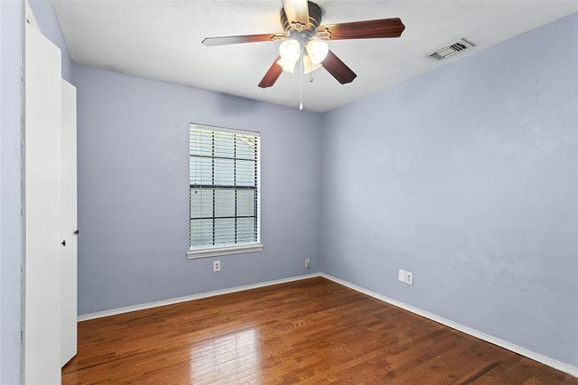 Empty room with wood finished floors and a ceiling fan | Image 17