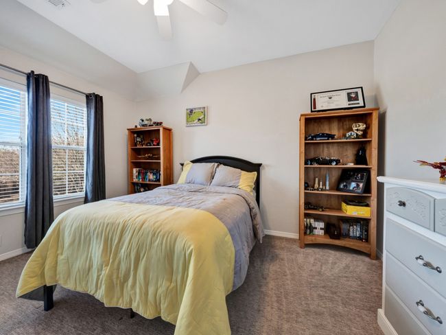 Carpeted bedroom with ceiling fan, visible vents, and baseboards | Image 39