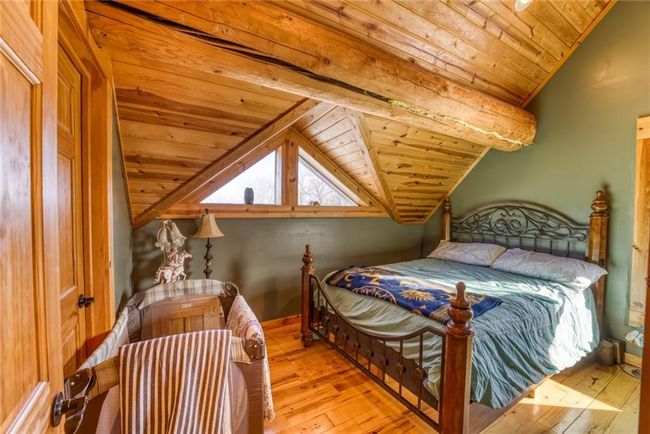 Bedroom featuring vaulted ceiling, light wood finished floors, baseboards, and wooden ceiling | Image 20