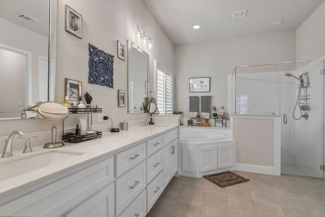Full bathroom featuring a bath, visible vents, a stall shower, and a sink | Image 17