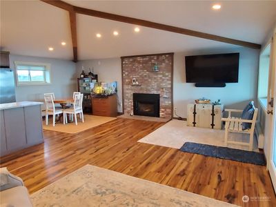 Spacious living area with vaulted ceilings and lots of canned lighting. | Image 3