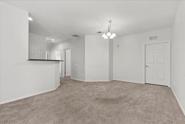 Carpeted empty room featuring a chandelier and recessed lighting | Image 16