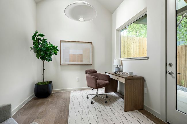 Office featuring lofted ceiling and a skylight | Image 9