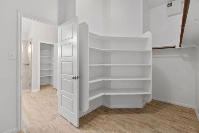 Spacious, walk-in primary closet with upgraded shelving | Image 21