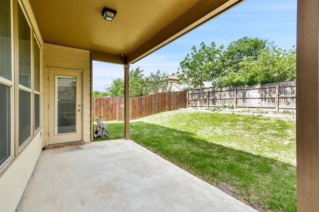 View of yard featuring a fenced backyard and a patio area | Image 28