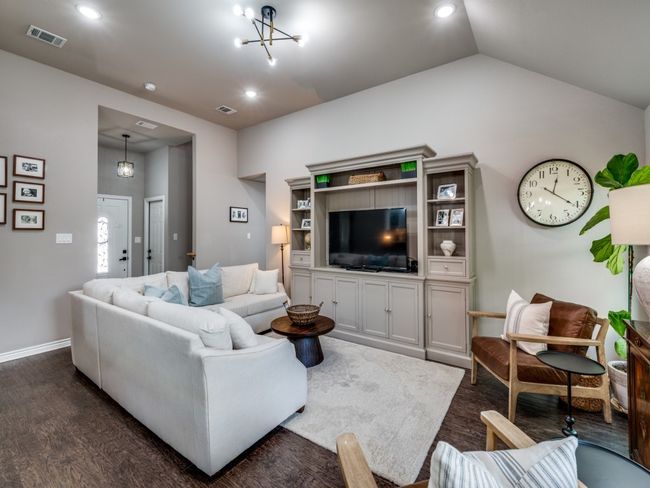 Living room featuring dark wood-style flooring, baseboards, lofted ceiling, and recessed lighting | Image 6