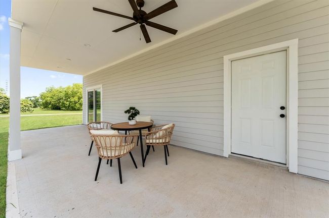 Spacious primary bedroom with direct balcony access and serene lake views. | Image 28