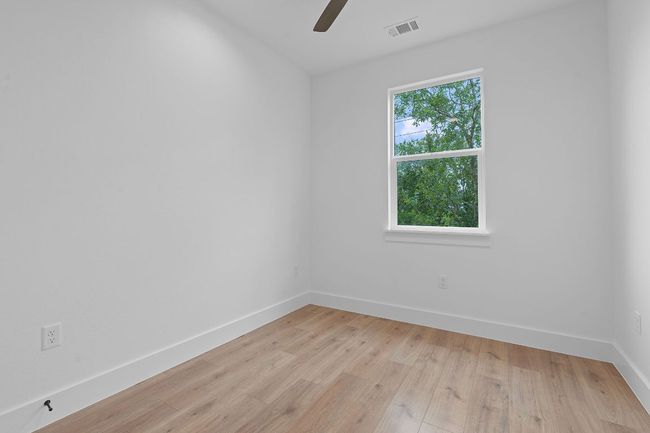 Spare room featuring baseboards, visible vents, light wood-style floors, and ceiling fan | Image 17