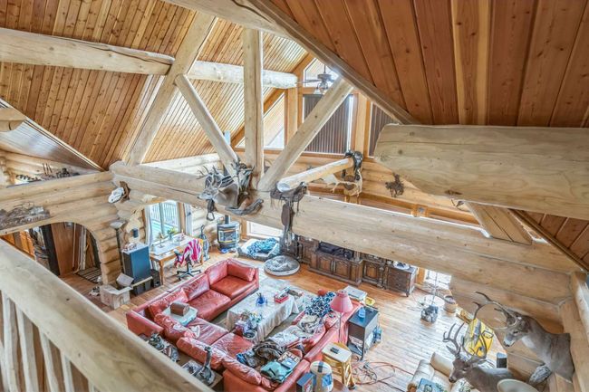 Living area with rustic walls, hardwood / wood-style floors, and wood ceiling | Image 35
