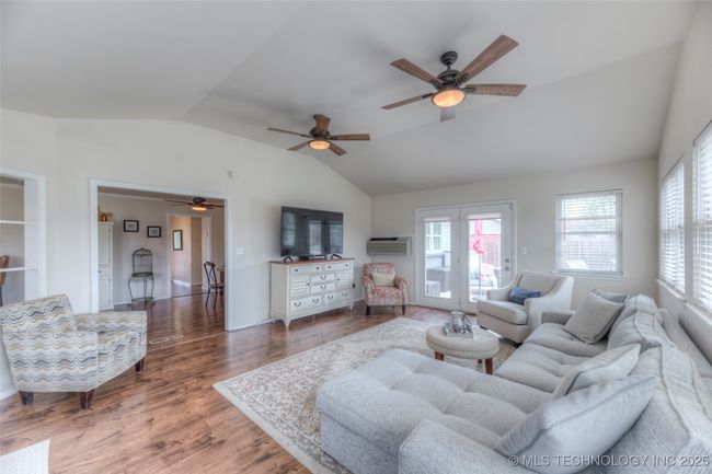 Another view. Two ceiling fans for air circulation and lots of windows for a bright sunny space. | Image 15