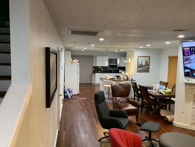 Living area featuring a textured ceiling, dark wood-style floors, and recessed lighting | Image 13