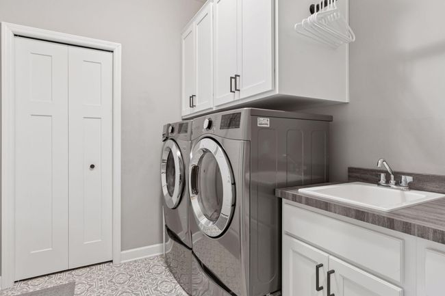 Upgraded laundry with pedistal washer/dryer, built in sink and extra built in cabinets | Image 33