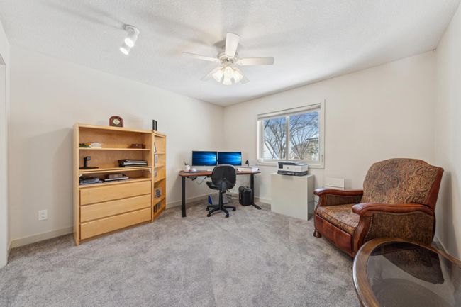 Upper Level 4th Bedroom or Versatile home office featuring built-in shelving, ample natural light, and plenty of space for workstations and seating. | Image 23