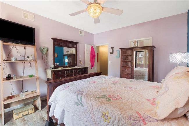 Bedroom with wood finished floors and a ceiling fan | Image 13