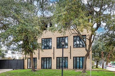 Side view of the home from Amherst. Both first and second floor windows open completely to the outside while third floor balcony is completely open | Image 2