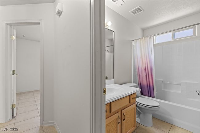 Full bathroom featuring tile patterned flooring, vanity, and shower / bathtub combination with curtain | Image 31