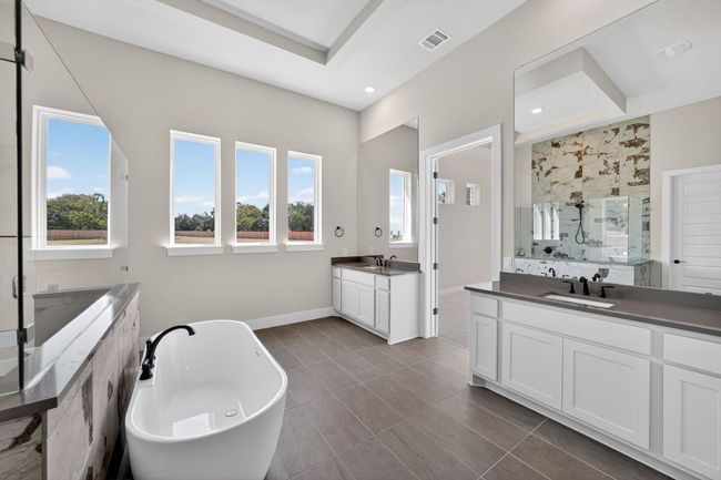 Full bathroom with a freestanding tub, a marble finish shower, and two vanities | Image 14
