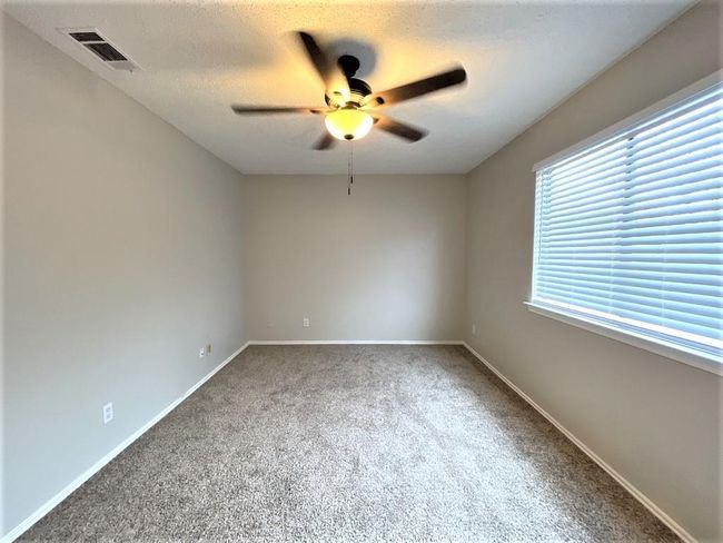 Unfurnished room with ceiling fan, carpet, and baseboards | Image 10