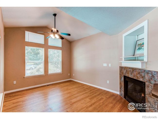 The living room boasts soaring cathedral ceilings and a cozy gas log fireplace | Image 8