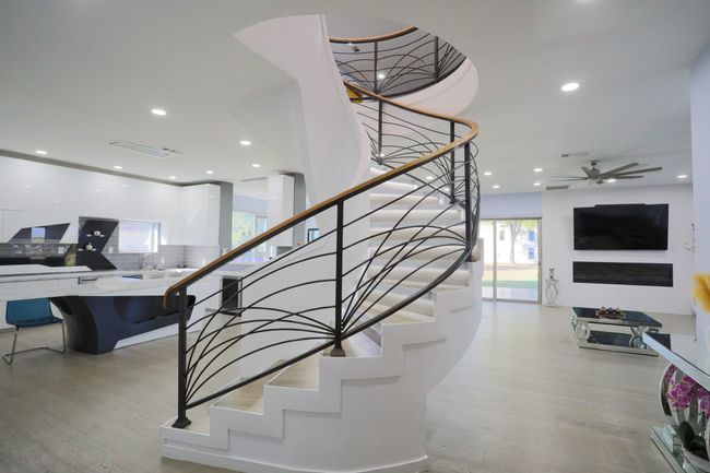 Staircase with wood-type flooring and ceiling fan | Image 4