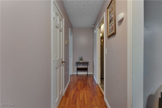 Hallway leading to 1st floor primary and 1st floor full bath | Image 16