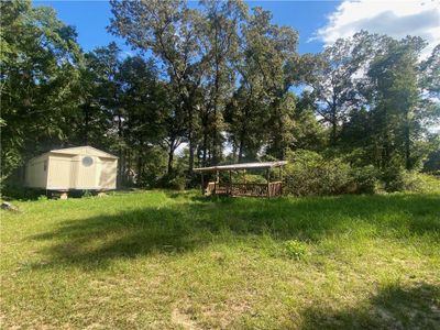 View of yard with a storage shed | Image 3