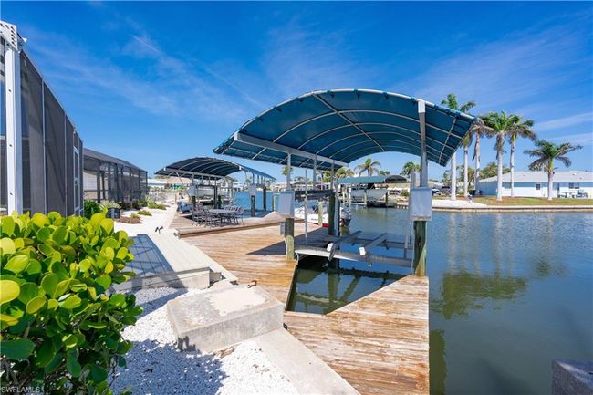 Dock area with a water view and covered boat lift | Image 22