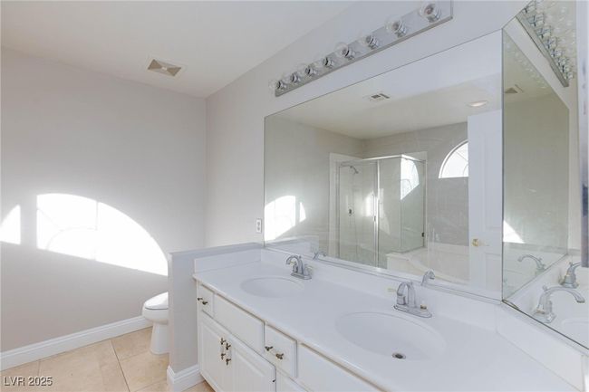 Bathroom with a sink, visible vents, and a stall shower | Image 29