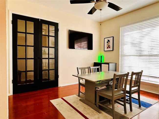 Dining room with french doors, wood finished floors, baseboards, and a ceiling fan | Image 10