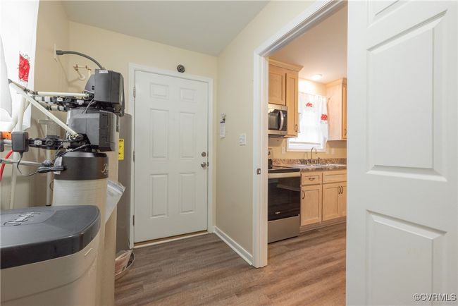 Kitchen featuring a sink, light brown cabinetry, light wood-style flooring, and appliances with stainless steel finishes | Image 17