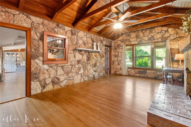 Living room with wood beam ceiling, oak floors, and ceiling fan | Image 10