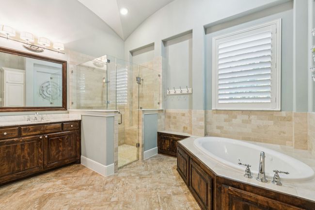 Primary bathroom with His and Her shower head system, a tub with jets, separate vanities | Image 18