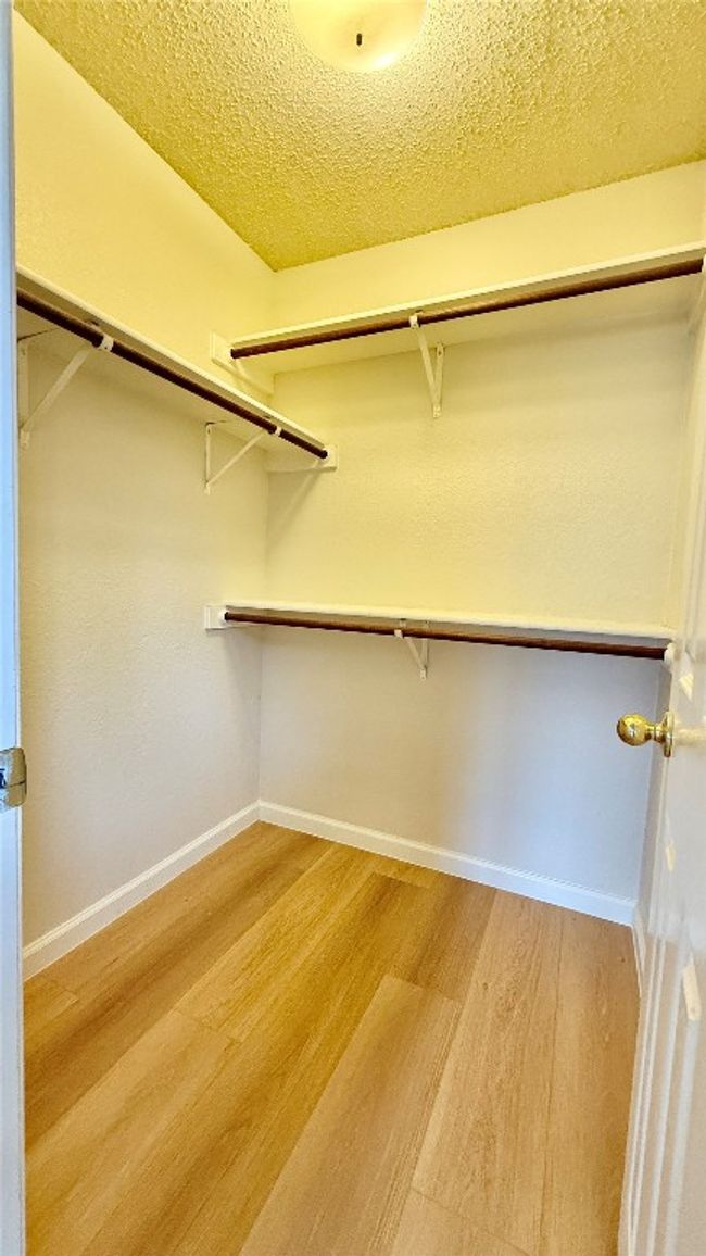 Spacious closet featuring light wood finished floors | Image 5
