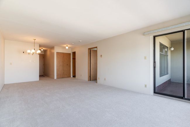 Unfurnished room with carpet and a chandelier | Image 10