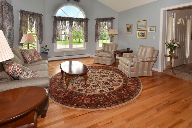 Beautiful living room with hardwood floors and cathedral ceiling. | Image 7