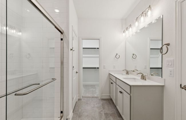 Modern owner's bath with dual vanities and a spacious shower *Real home pictured | Image 10